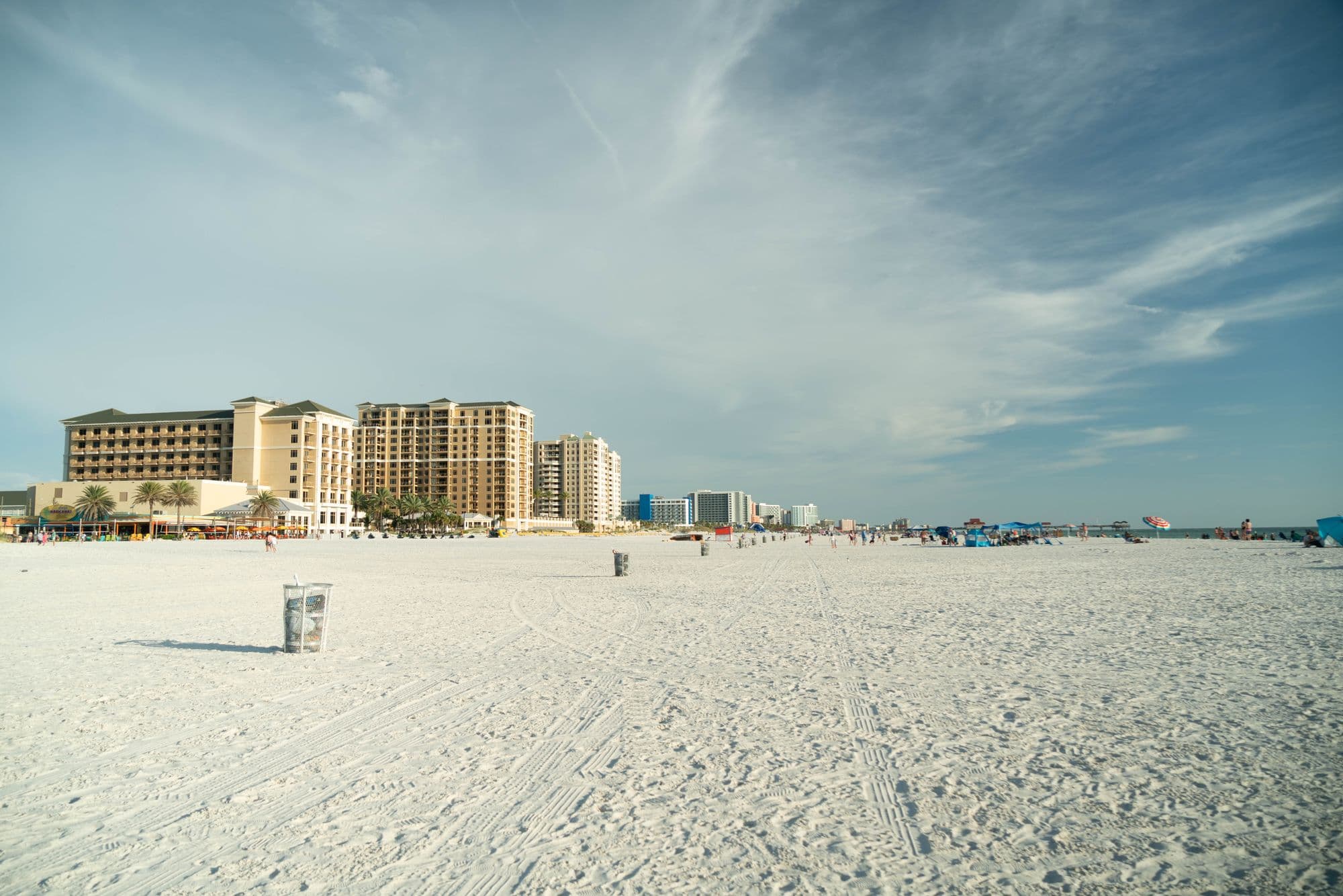 Clearwater Beach under a bright sky, hotels along the sand.